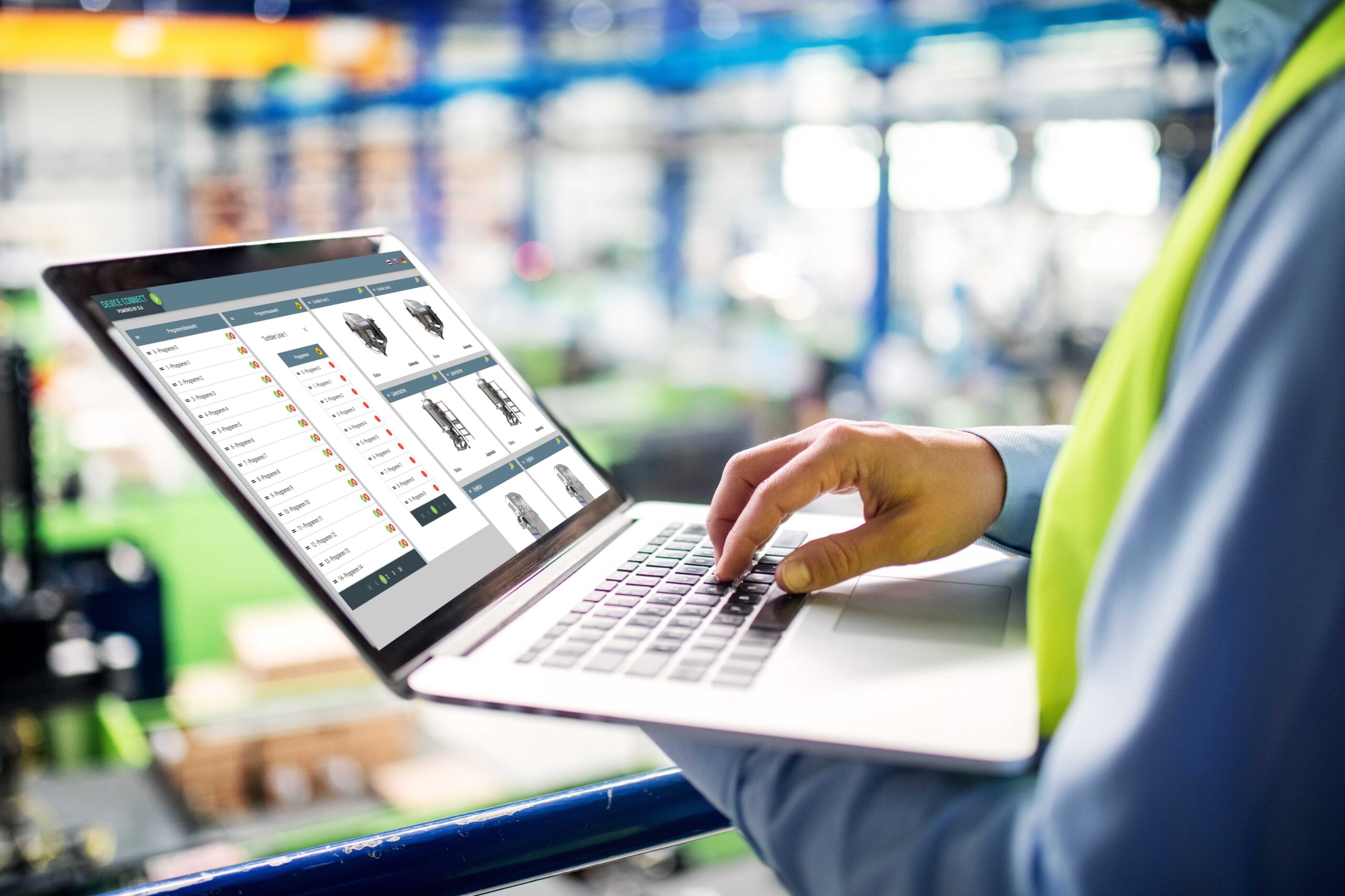 Unrecognizable technician or engineer with laptop standing in industrial factory